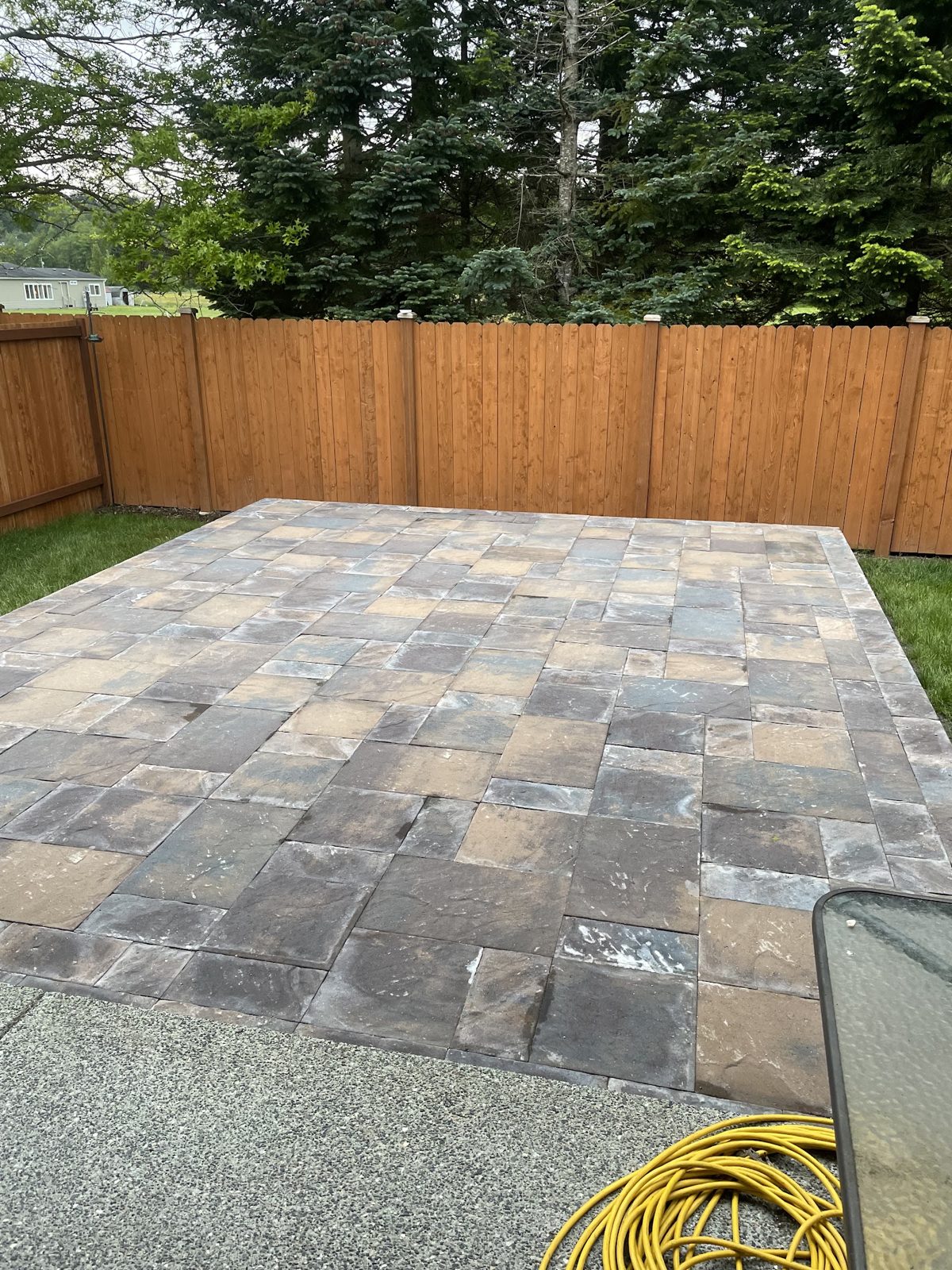 New paver patio with fresh sod and cedar fence